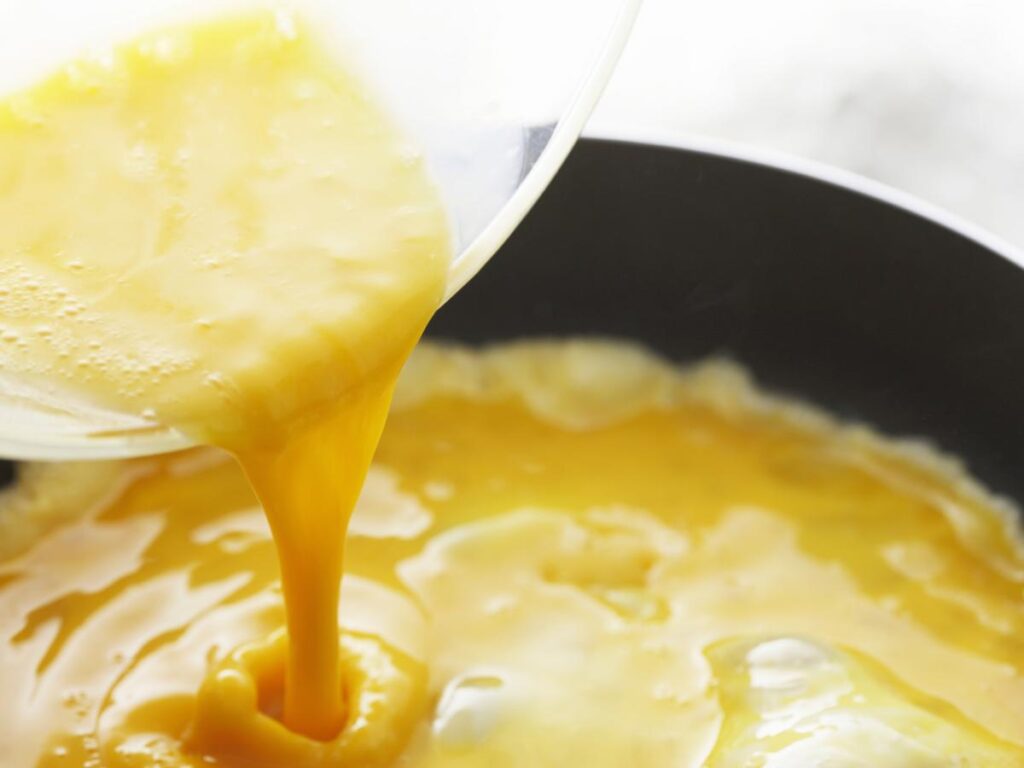 Egg Mixture Pouring into Pan
